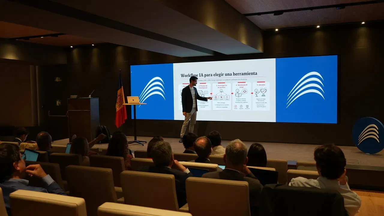 A speaker points at a framework for choosing tools on a wide screen, in front of a full auditorium